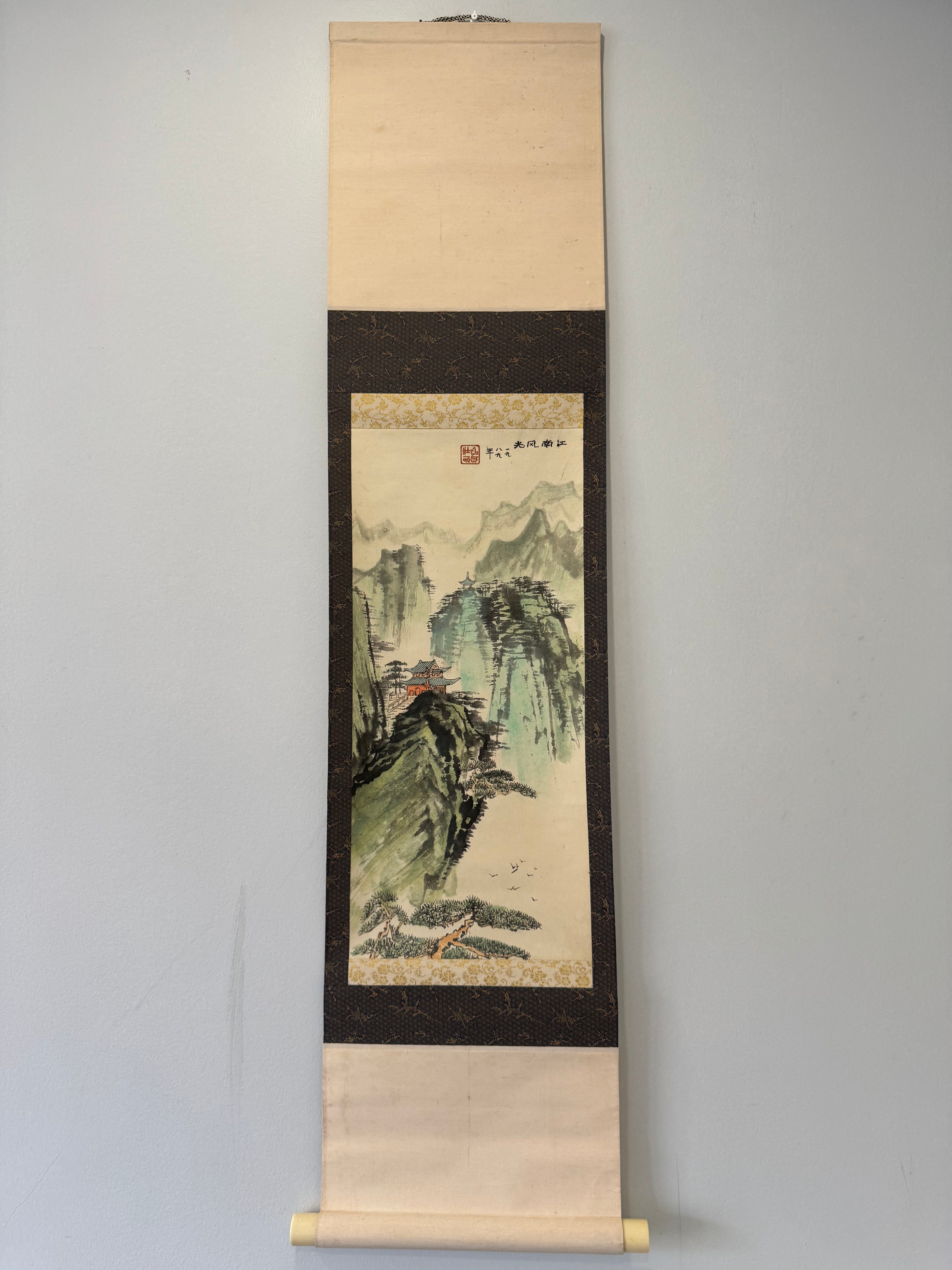 Traditional landscape painting on a vertical scroll against a plain background
