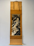 Decorative scroll with a dragon design on a plain wall