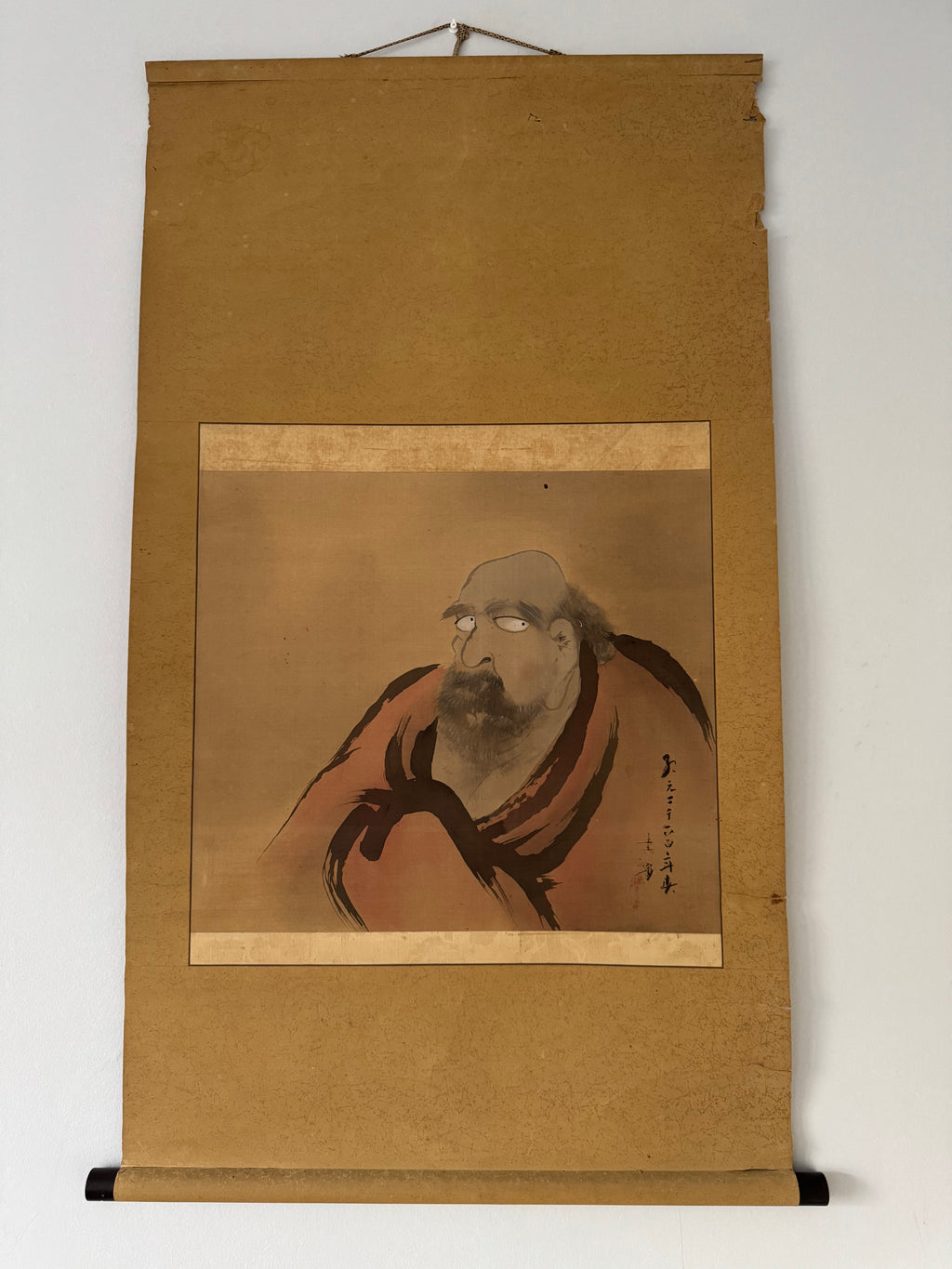 Traditional Japanese scroll with a portrait of a man on a plain background