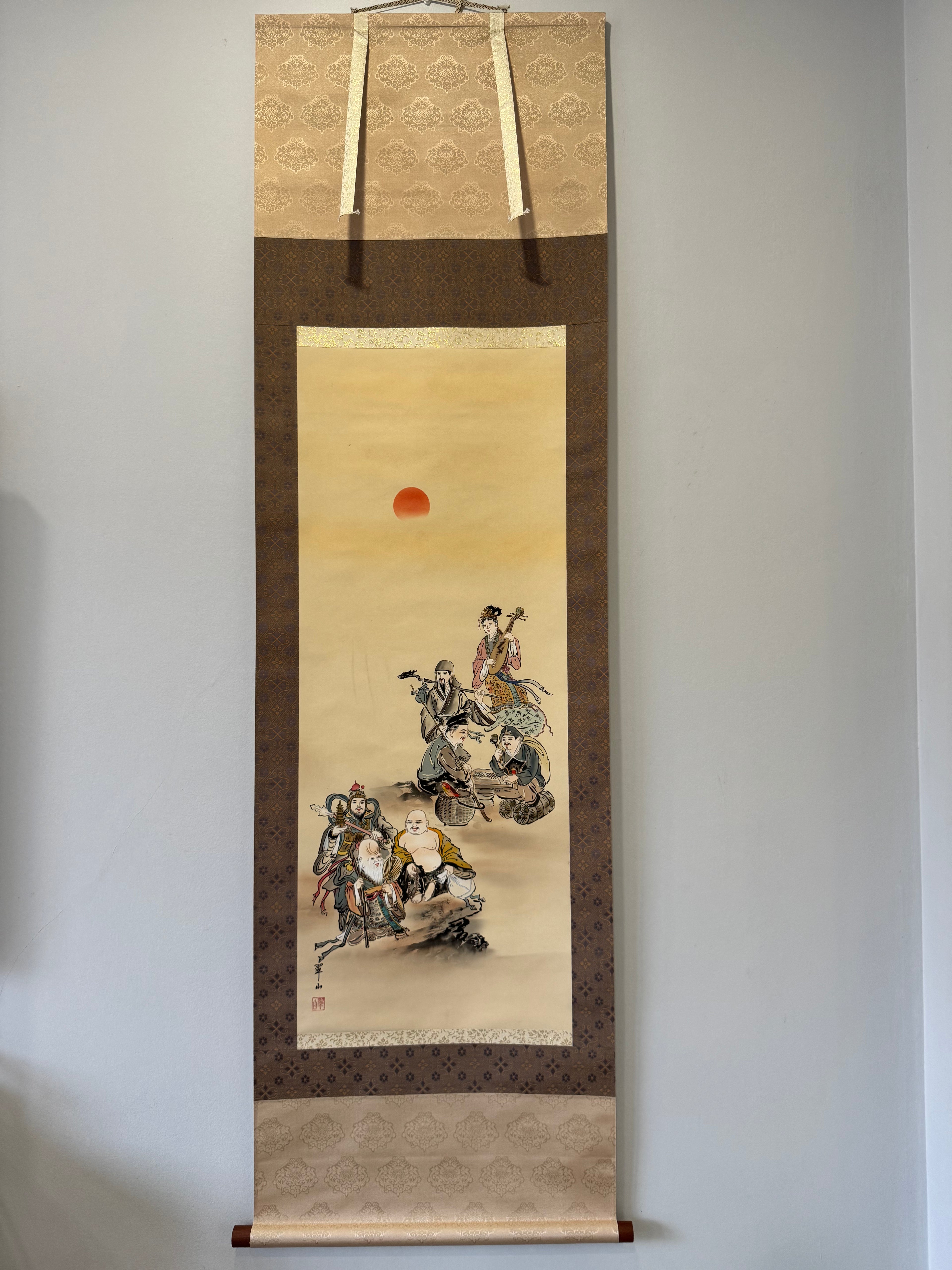 Traditional Japanese scroll painting hanging on a wall