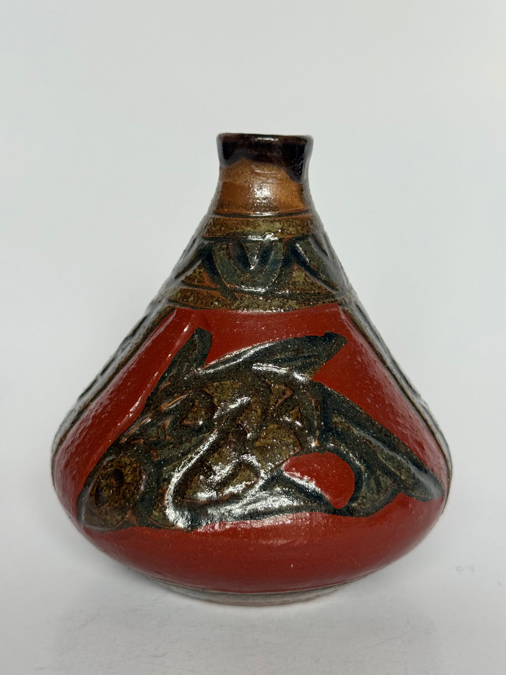 Ceramic vase with red and brown design on a white background