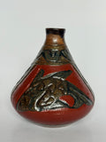 Ceramic vase with red and brown design on a white background