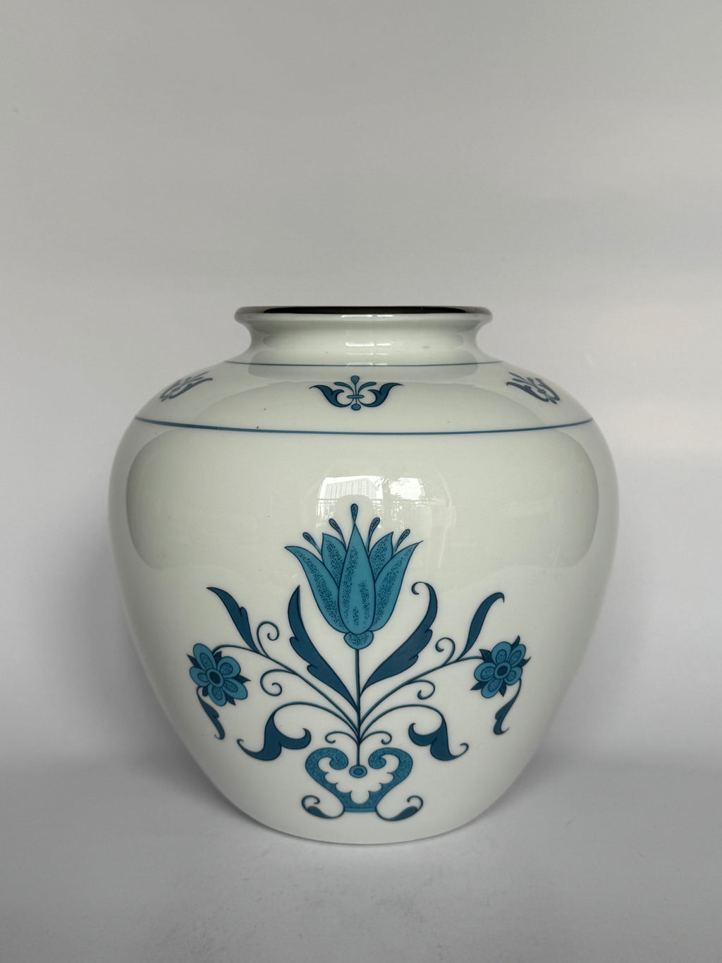 White vase with blue floral patterns on a white background