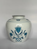 White vase with blue floral patterns on a white background