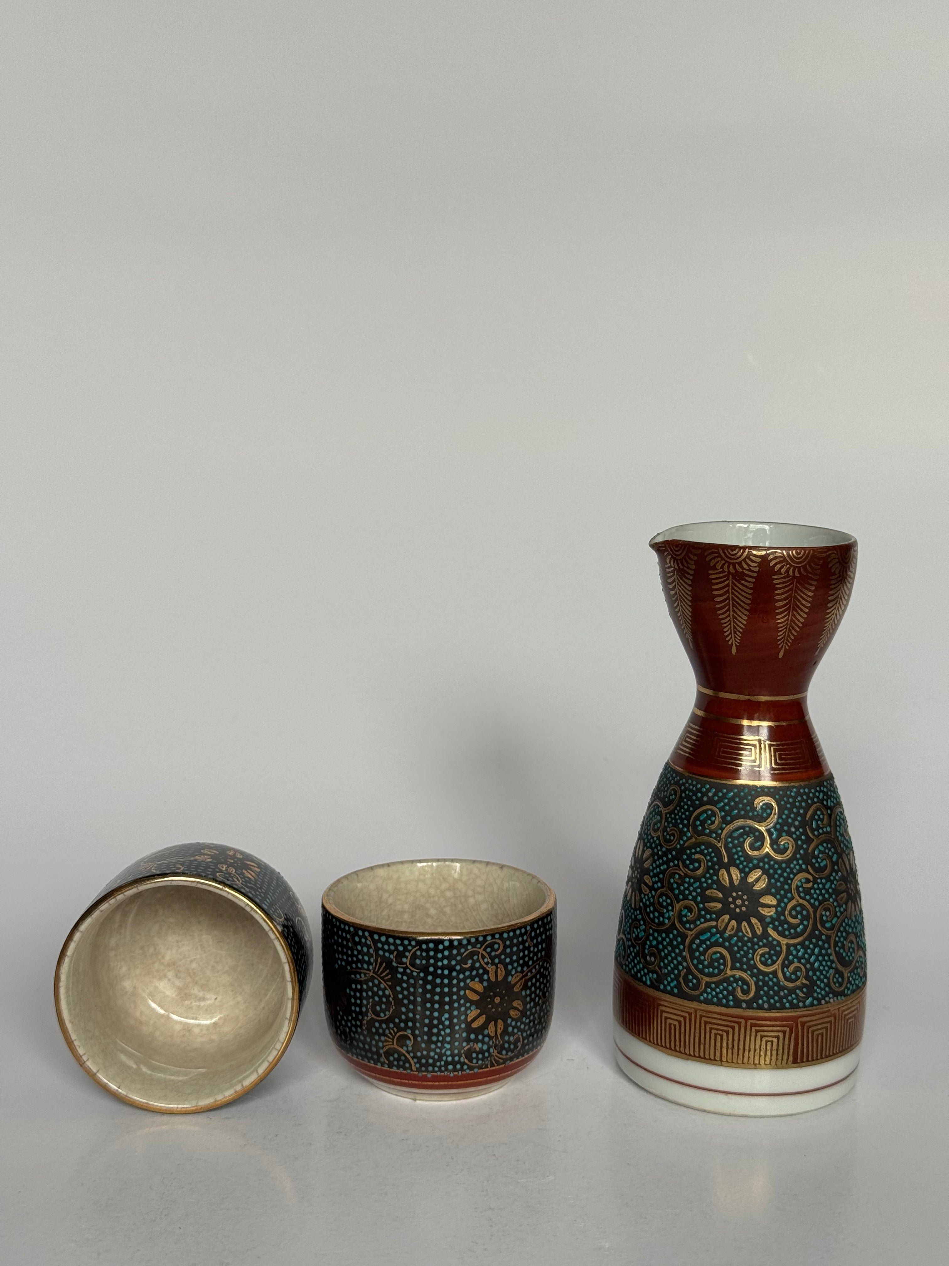 Ceramic sake set with a bottle and two cups on a gray background