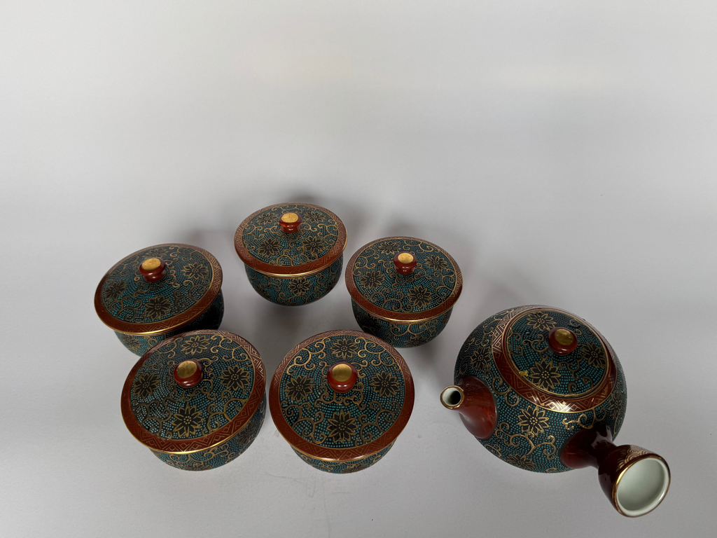 Set of ceramic containers with decorative lids on a white background