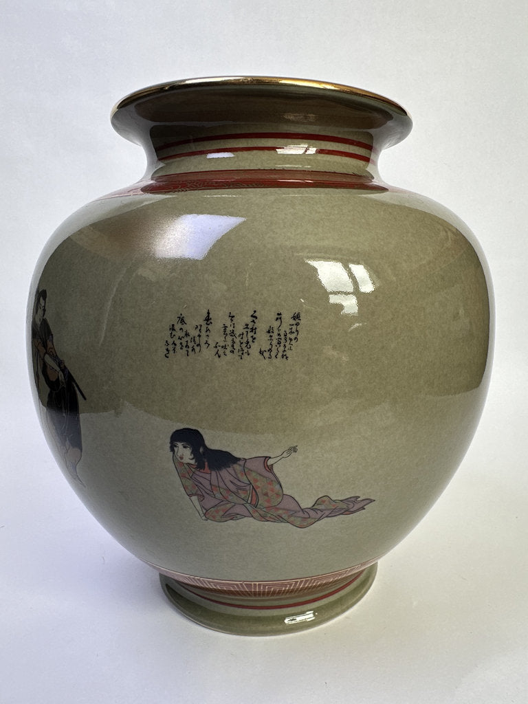 A ceramic vase with a glossy, rounded body in a muted olive-green glaze, decorated with traditional Japanese-style figures and black calligraphy. The vase features a flared rim with a gold accent and a reddish-brown band near the neck, and a matching reddish-brown patterned base.