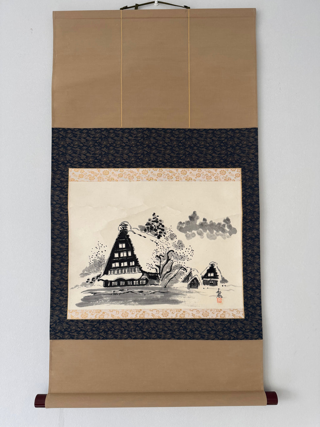 Traditional Japanese scroll with landscape design on a beige background