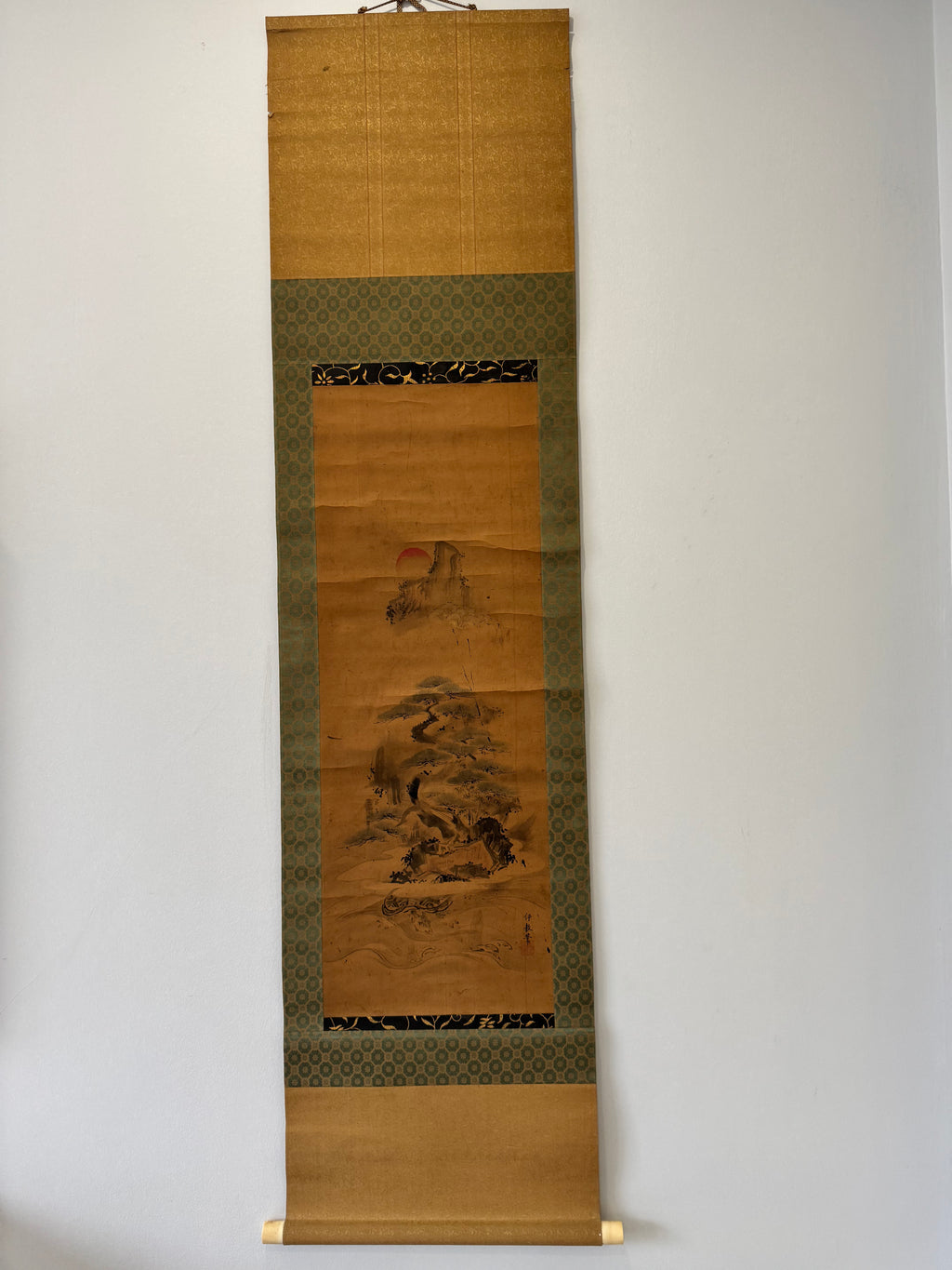 Traditional Japanese scroll with landscape design on a plain background