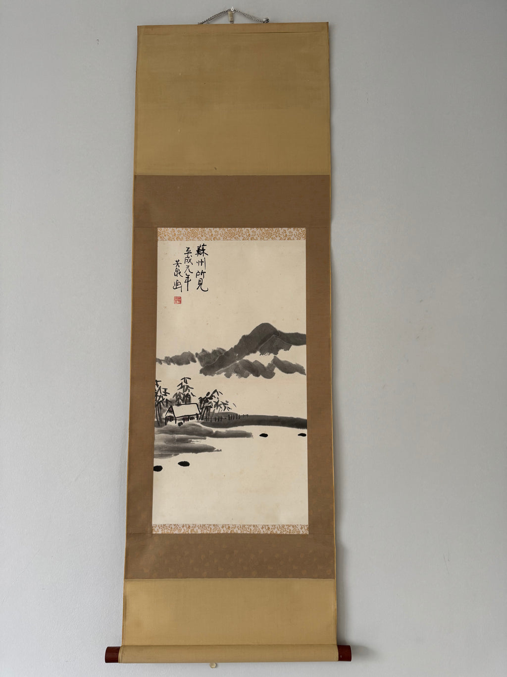 Traditional landscape painting on a hanging scroll with gold border