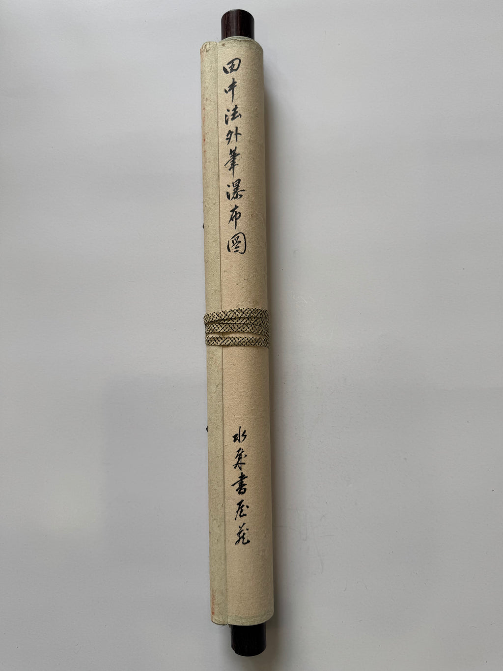 Roll of paper with calligraphy on a gray background