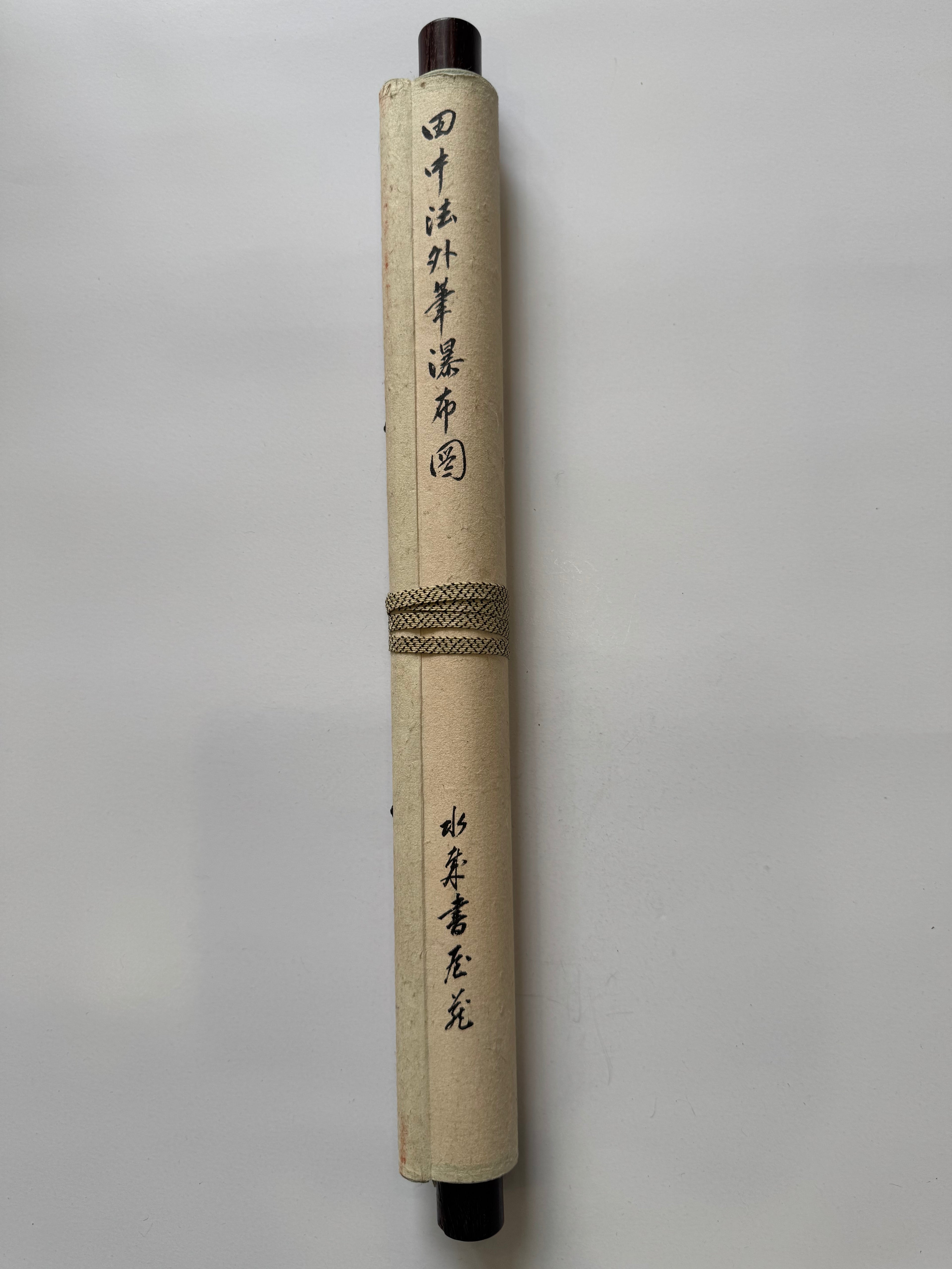 Roll of paper with calligraphy on a gray background