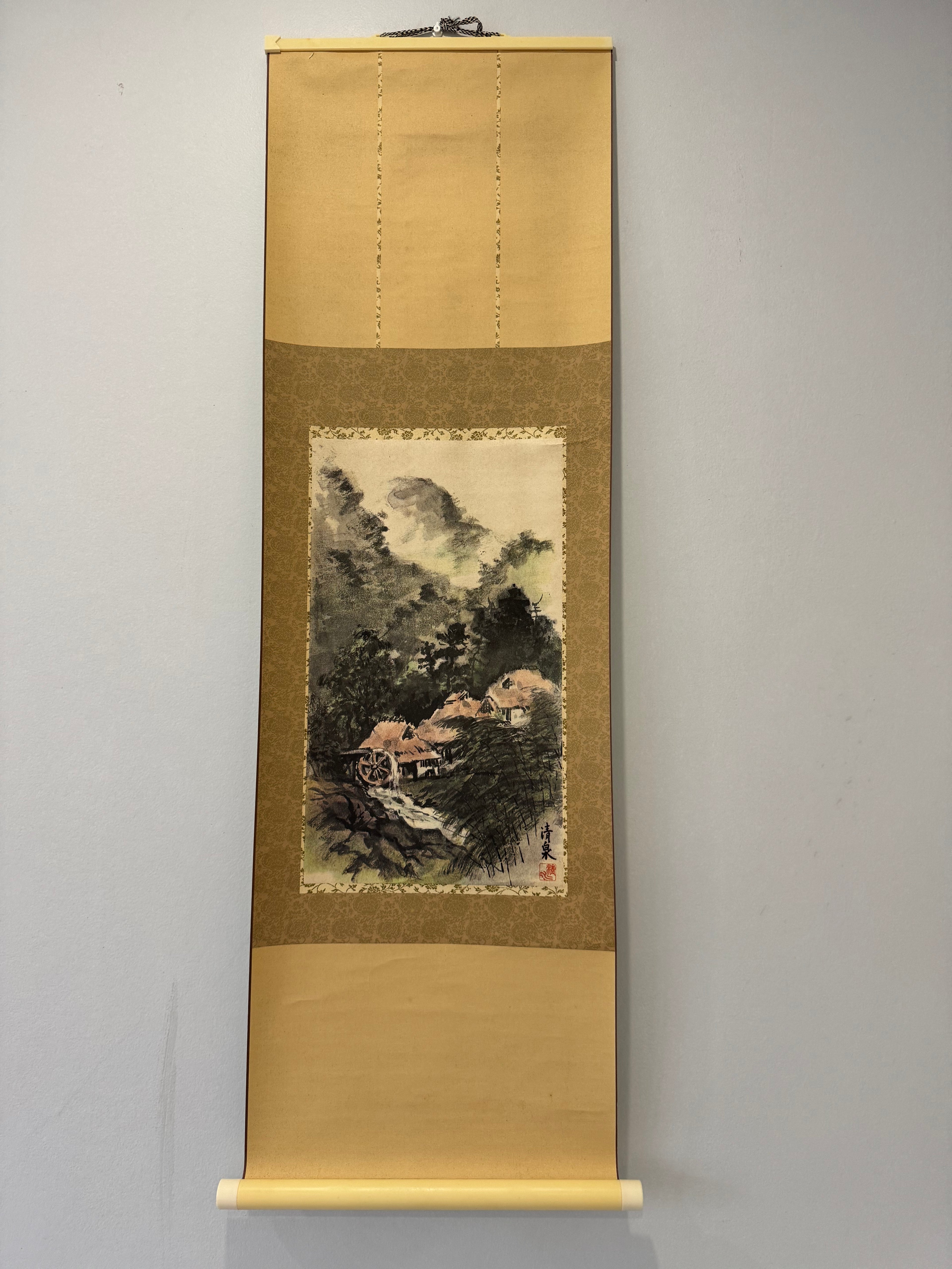 Traditional Japanese scroll with landscape painting on a plain background