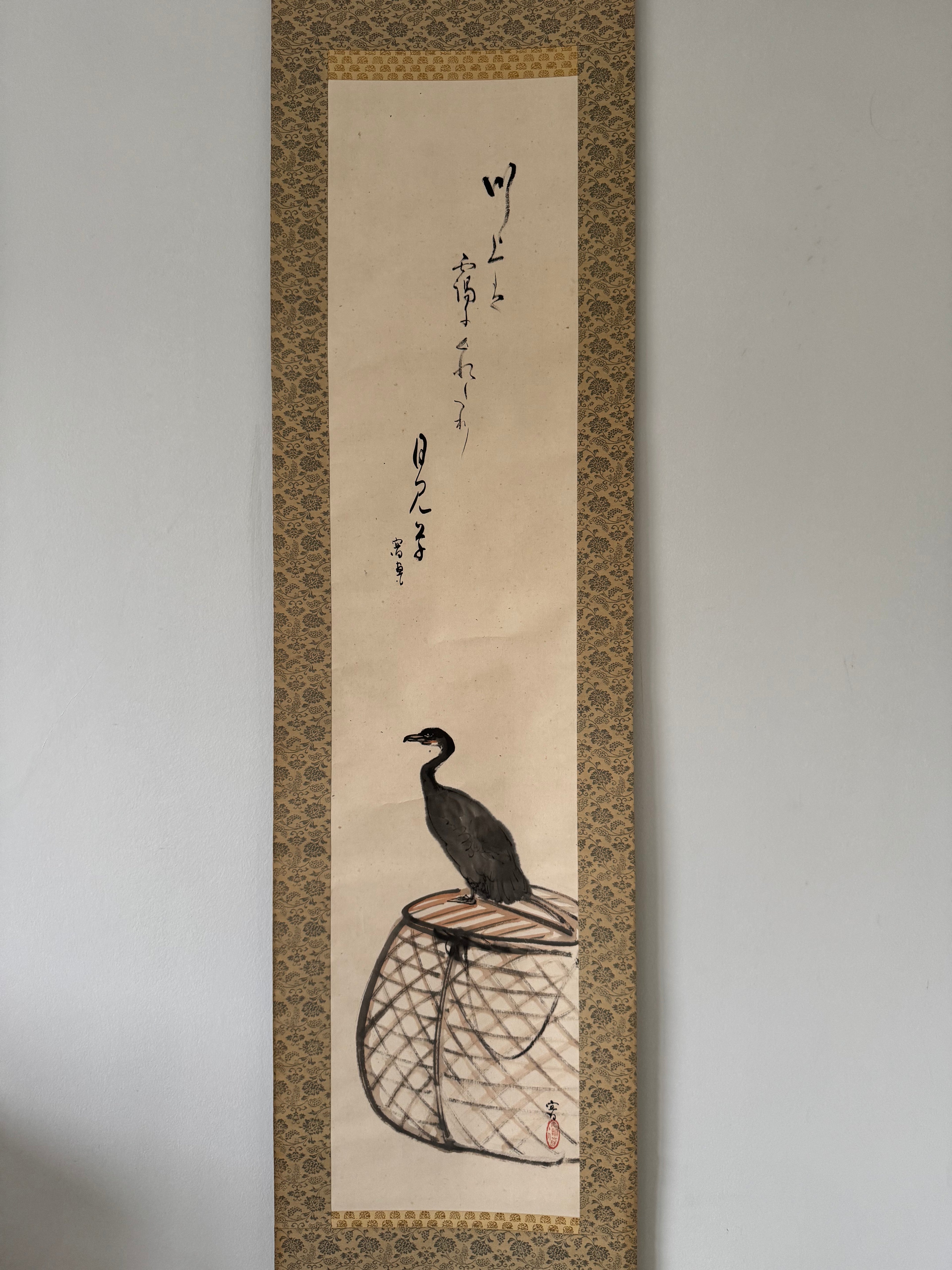 Traditional Japanese artwork with a bird on a perch, framed with decorative border.