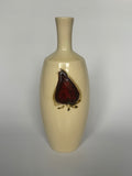 Beige ceramic vase with a red and black design on a gray background