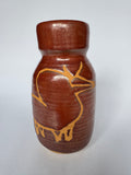 Brown ceramic vase with gold deer design on a white background