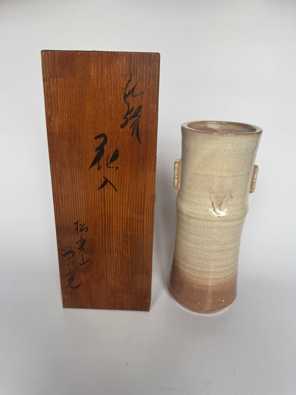 Ceramic vase with wooden box on a white background