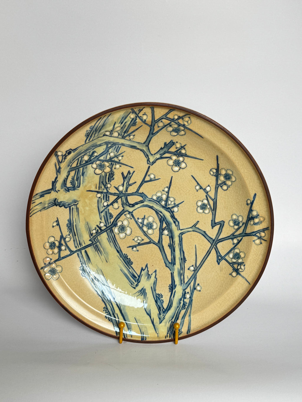 Ceramic plate with floral design on a beige background