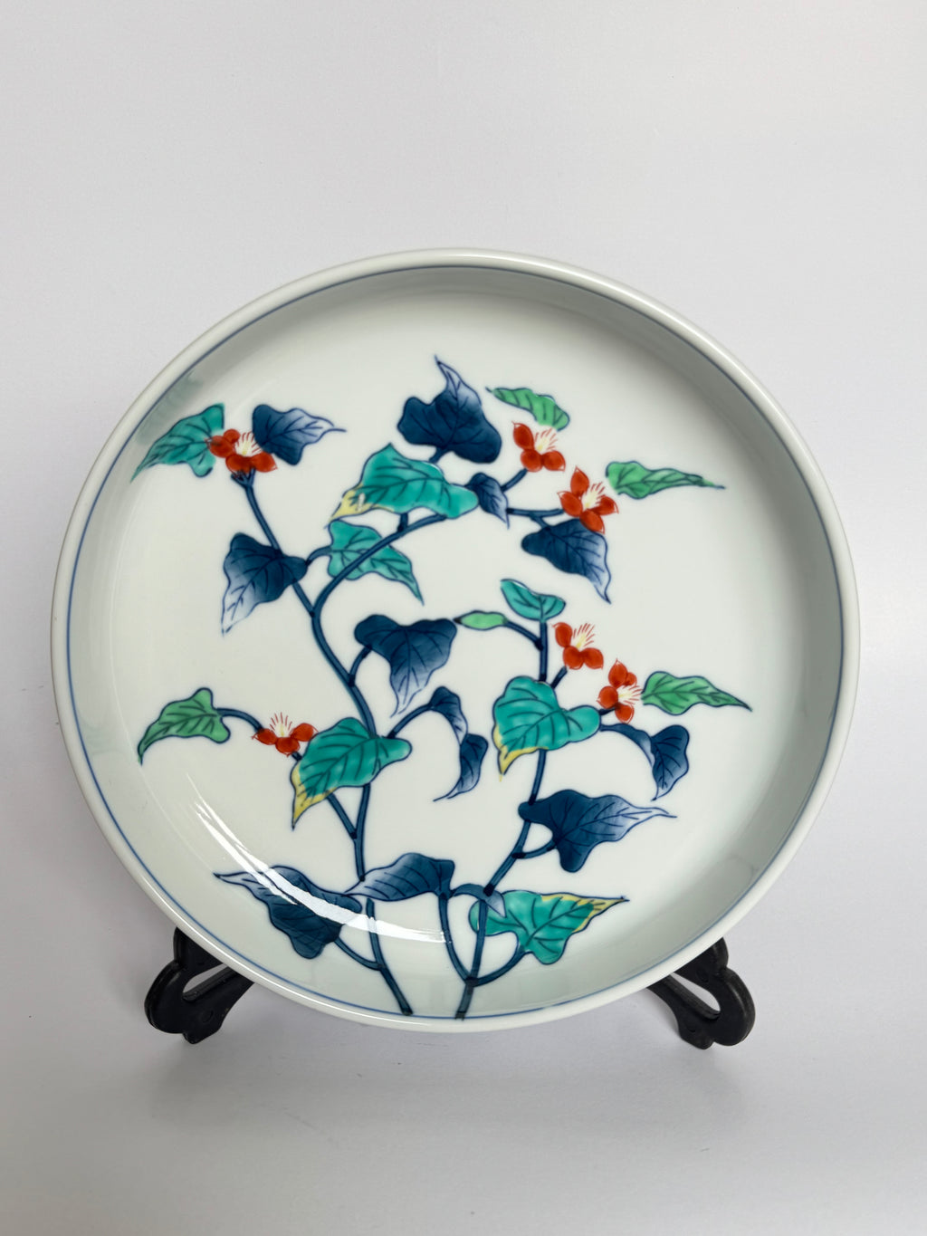Decorative ceramic plate with floral design on a white background