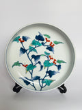 Decorative ceramic plate with floral design on a white background