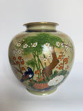 Decorative vase with nature-themed design on a white background
