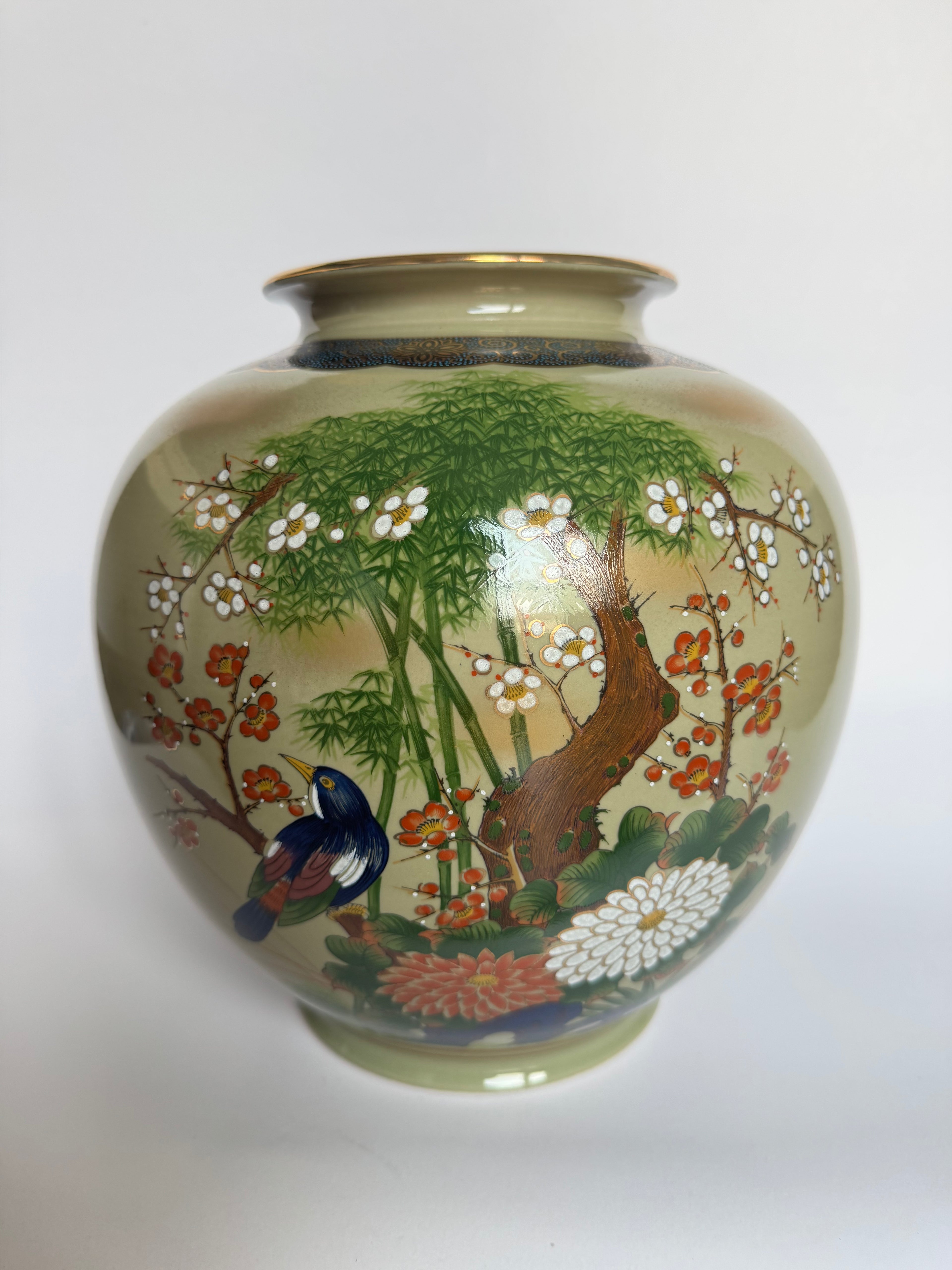 Decorative vase with nature-themed design on a white background