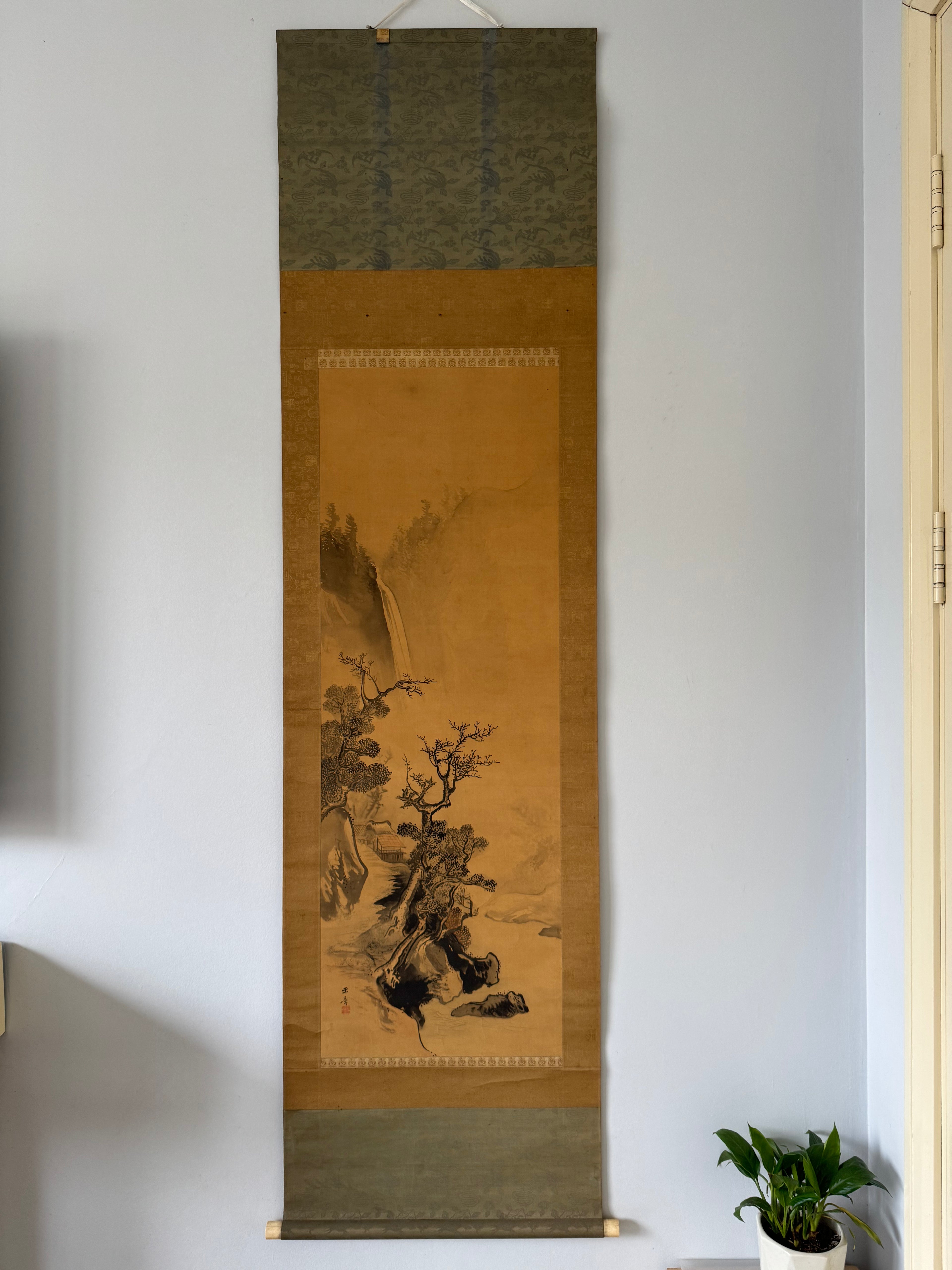 Traditional Japanese scroll painting hanging on a wall