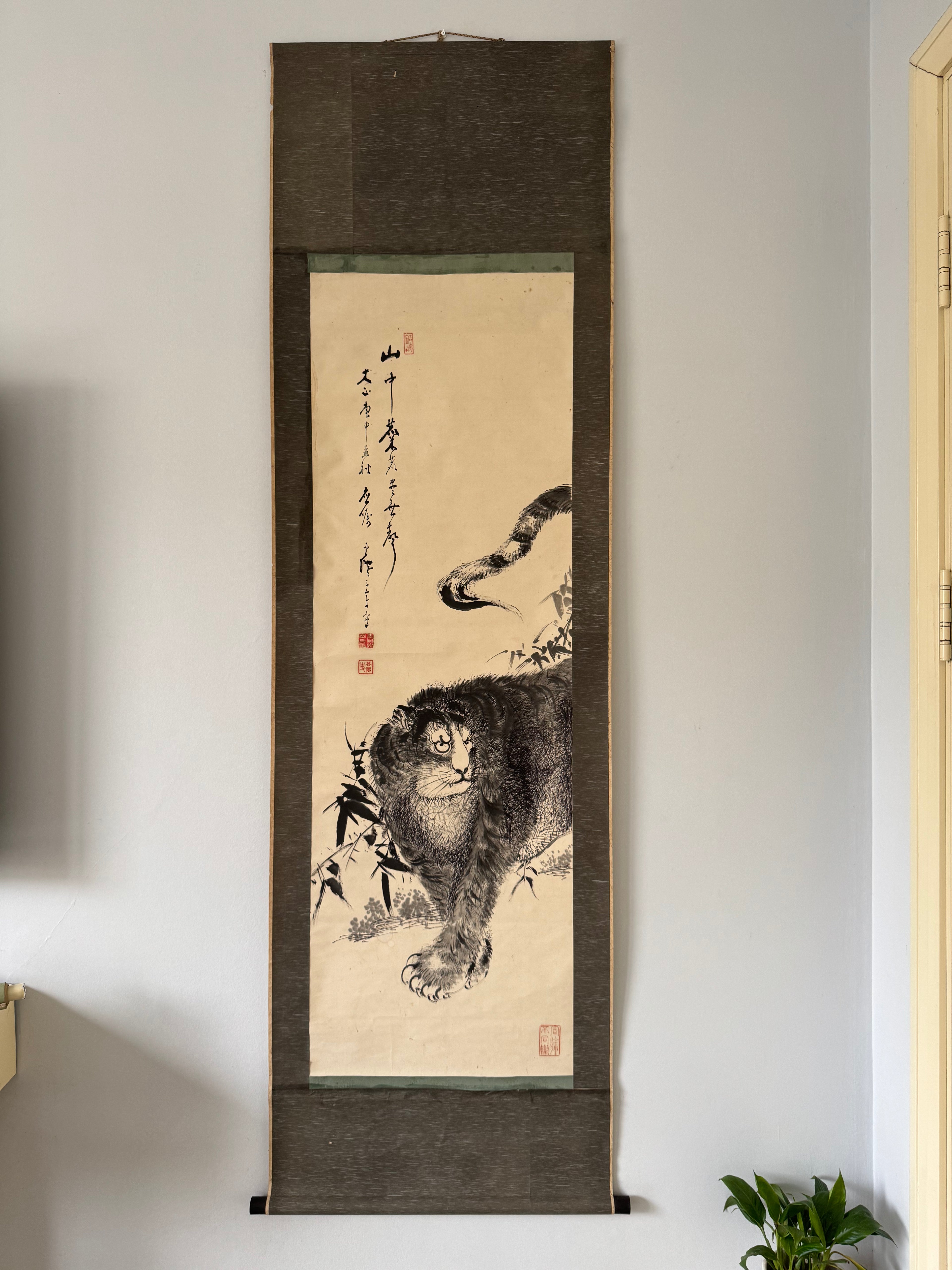 Traditional Japanese painting of a Tiger in a wooden frame on a wall.