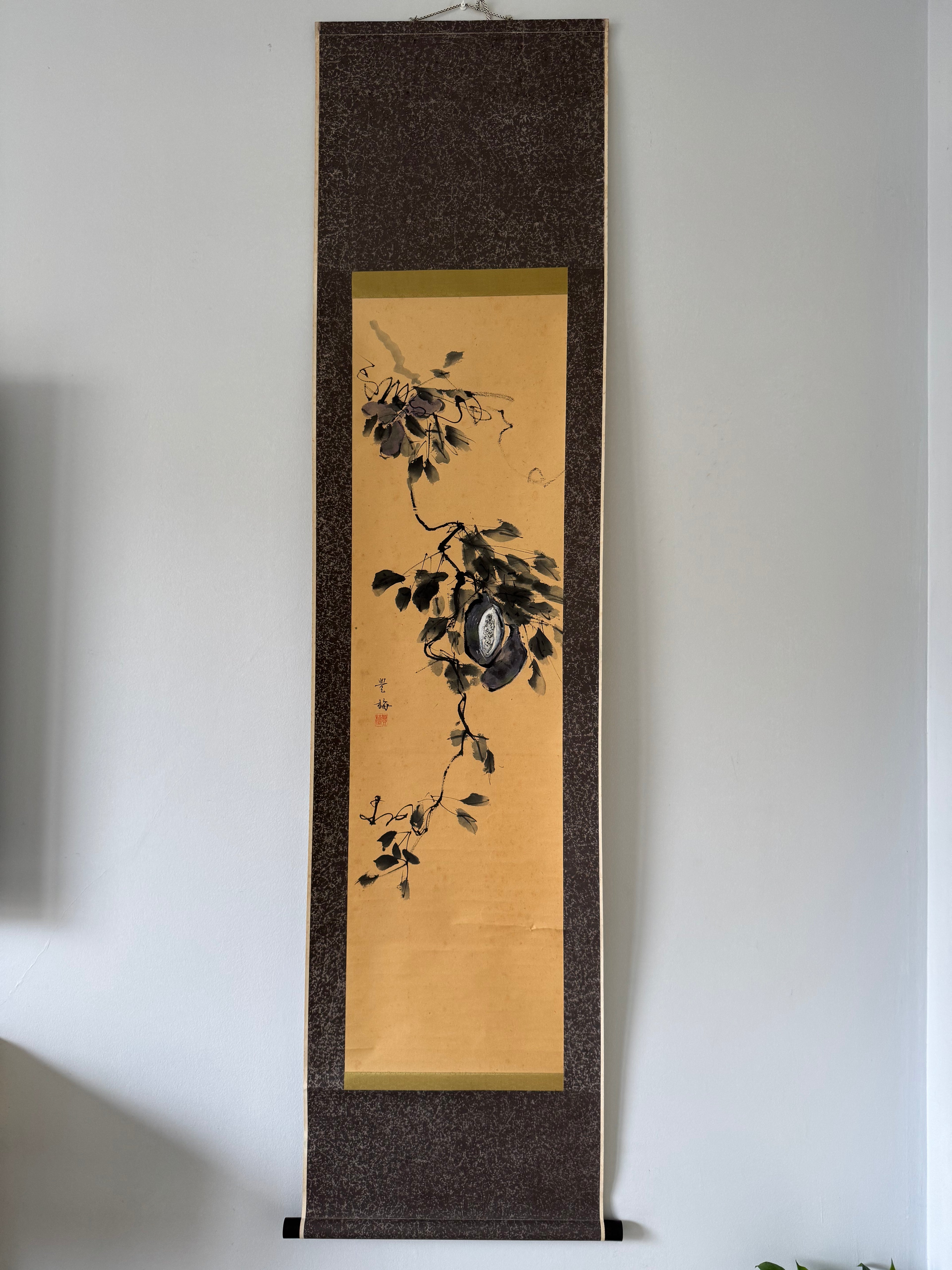 Traditional Japanes scroll with floral design on a plain wall