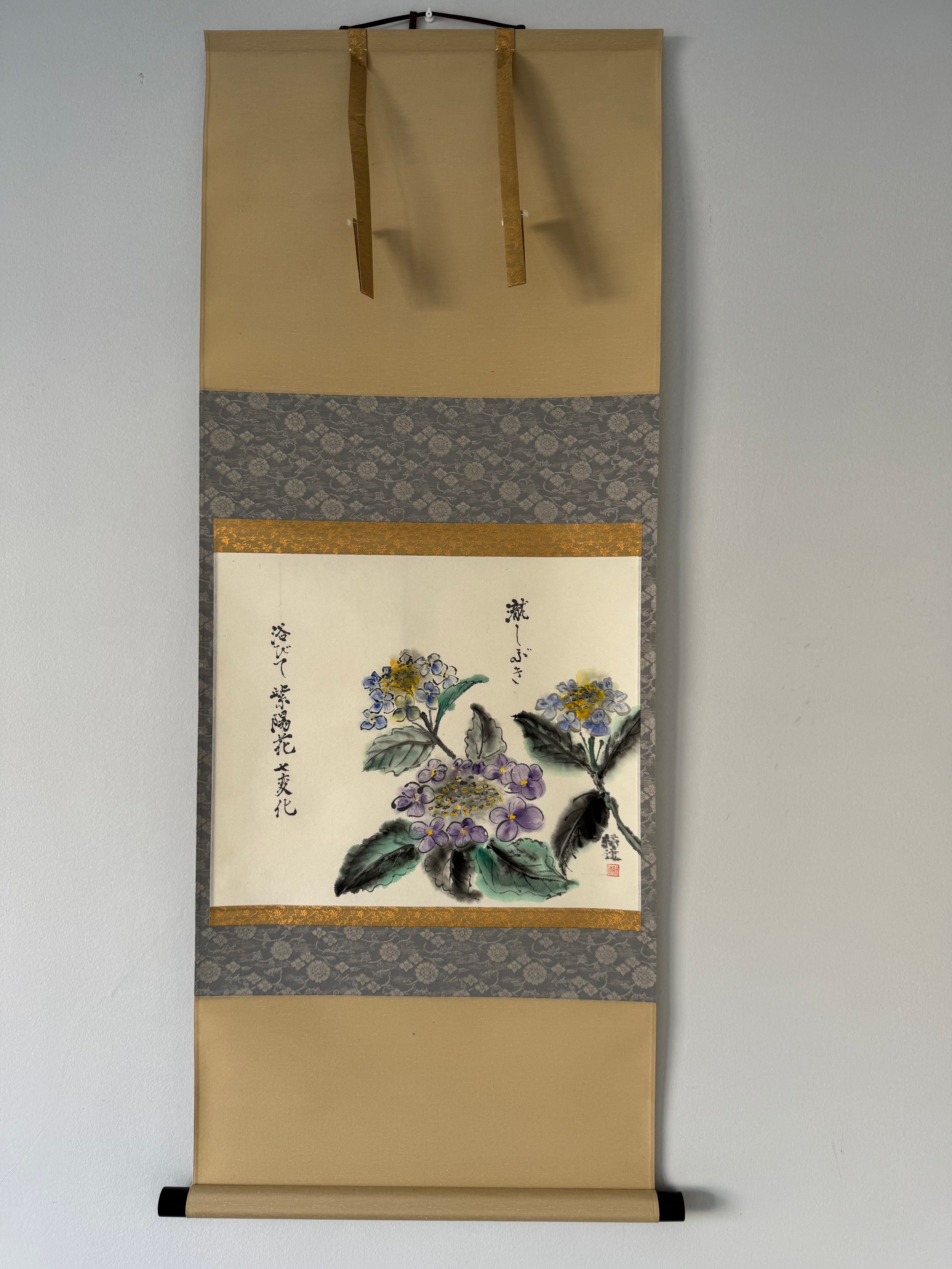 Traditional Japanese scroll with floral design on a plain background