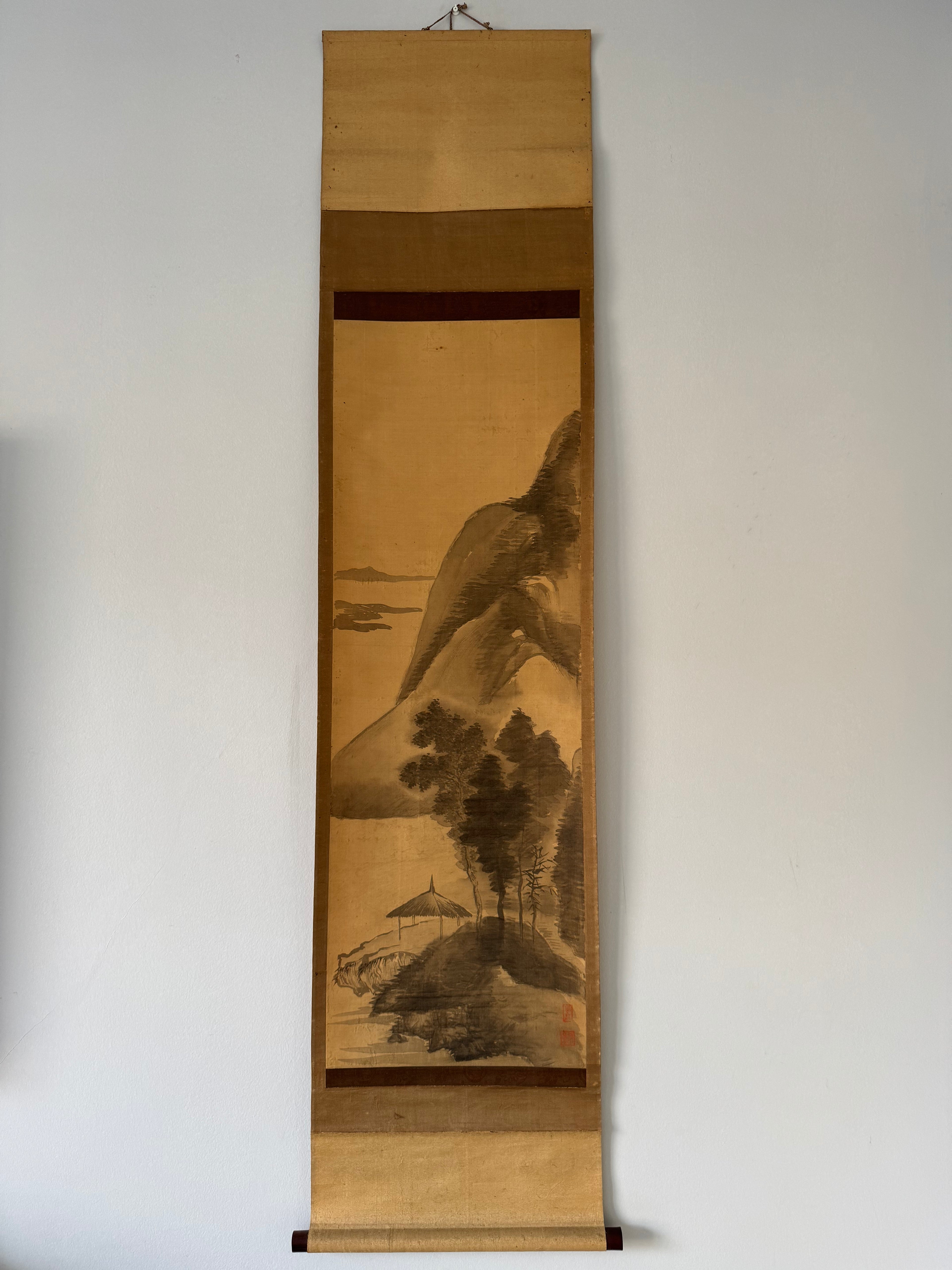 Traditional Japanese landscape scroll on a plain wall