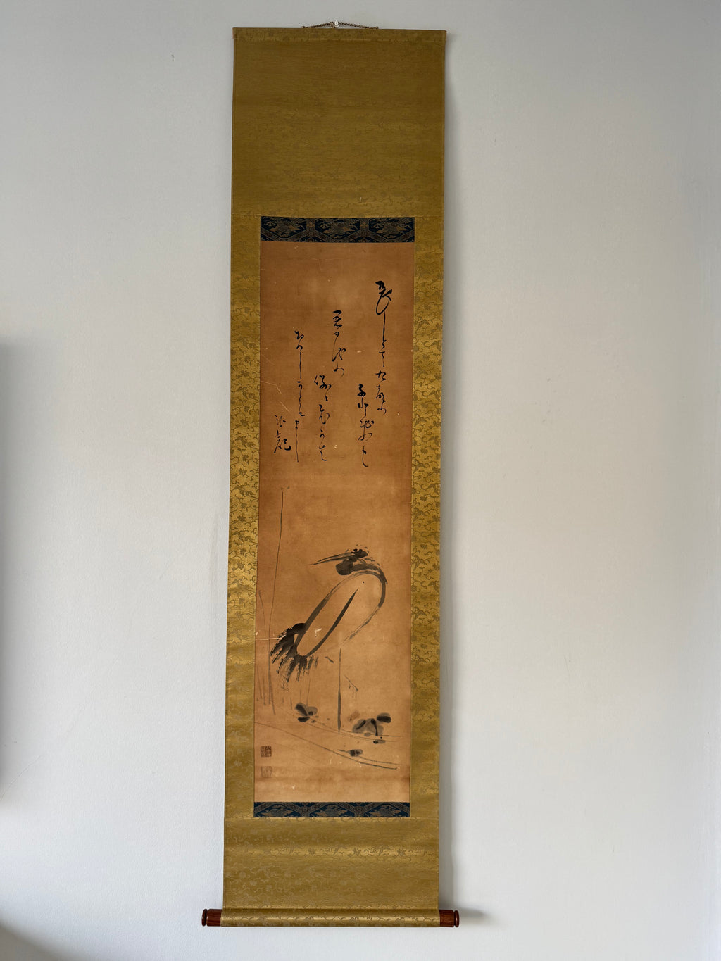 Vertical scroll with artistic depiction of birds on a plain wall