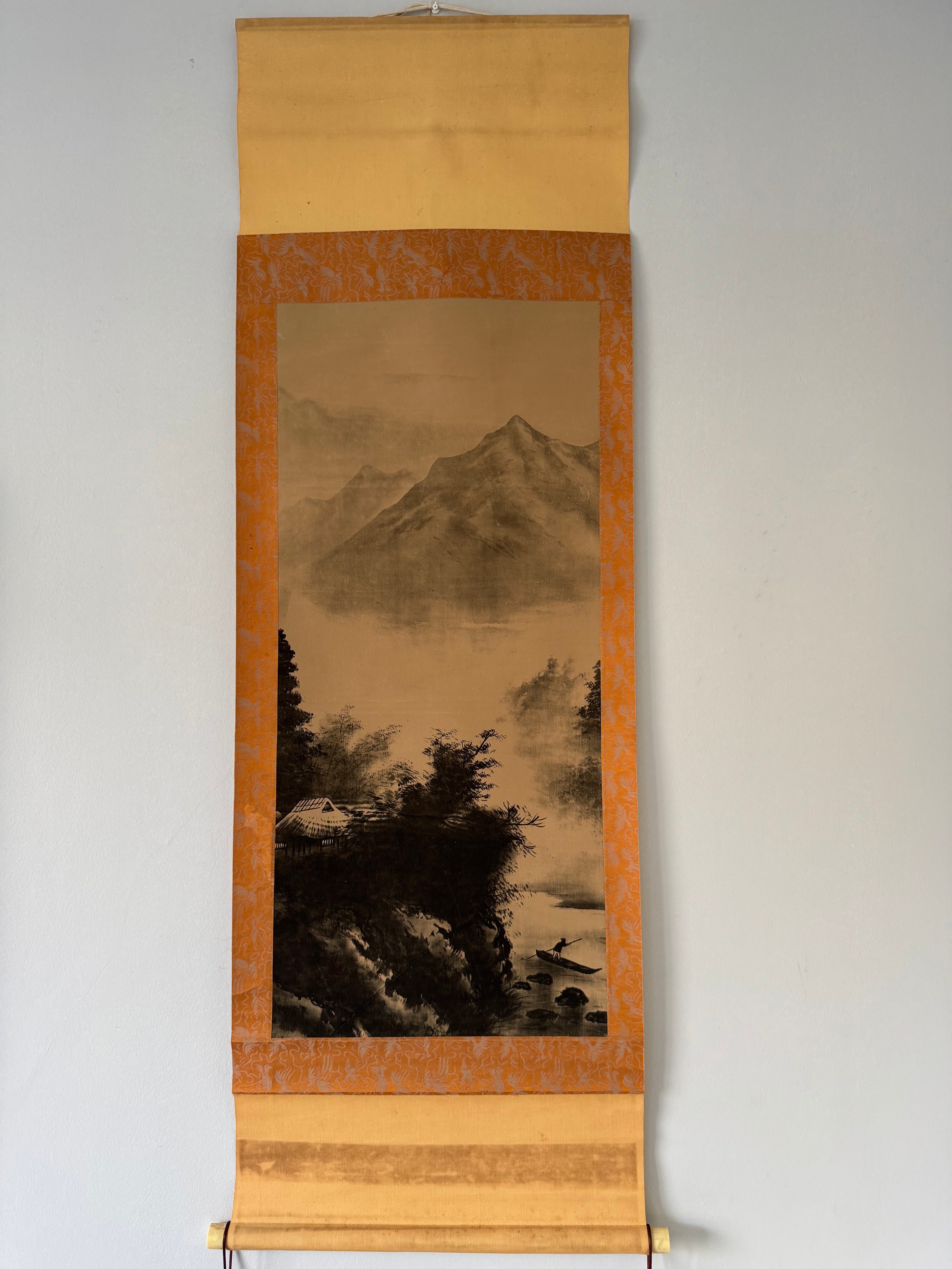 Traditional scroll with landscape painting on a plain background
