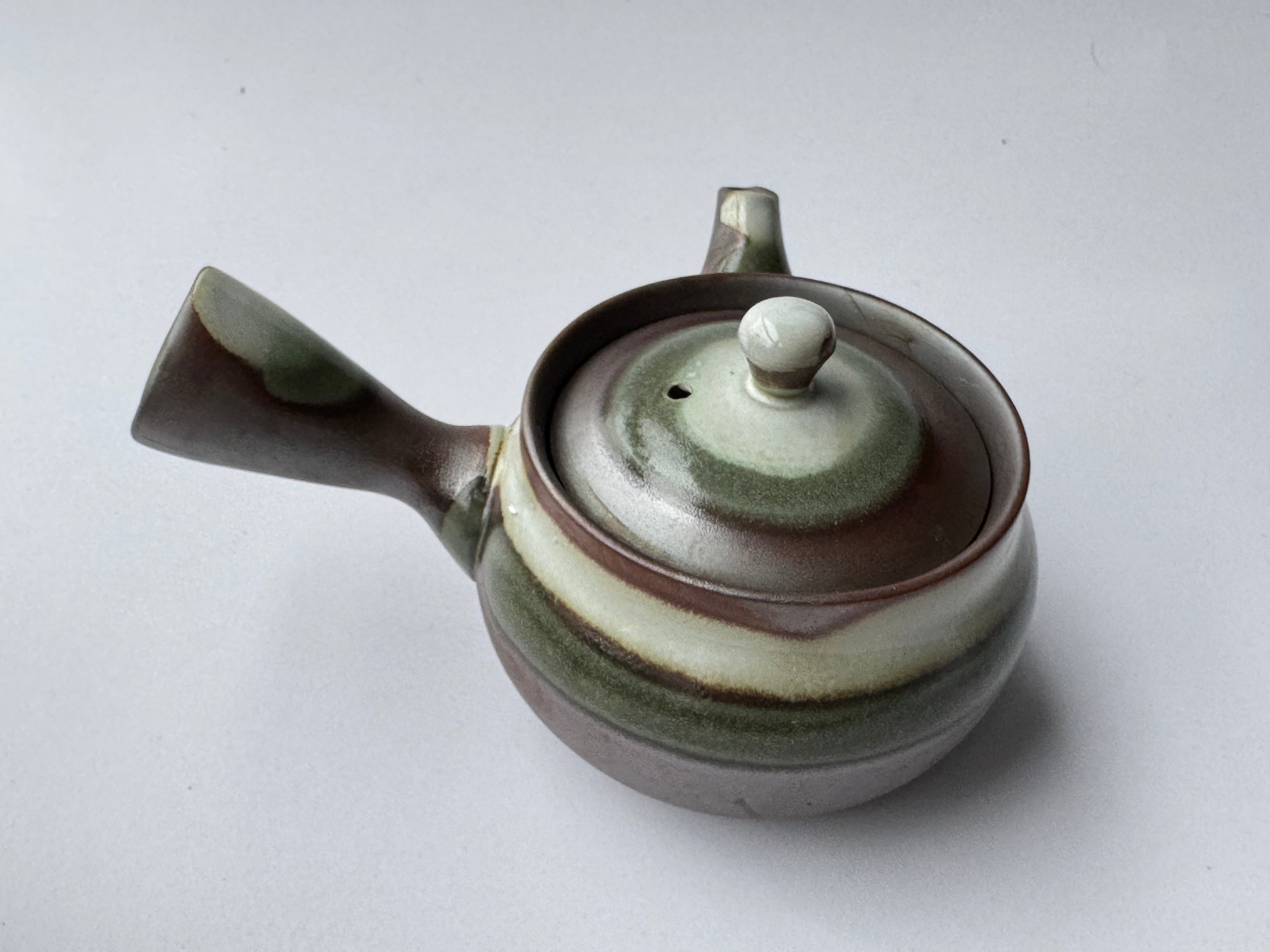 Ceramic teapot with a lid on a white background