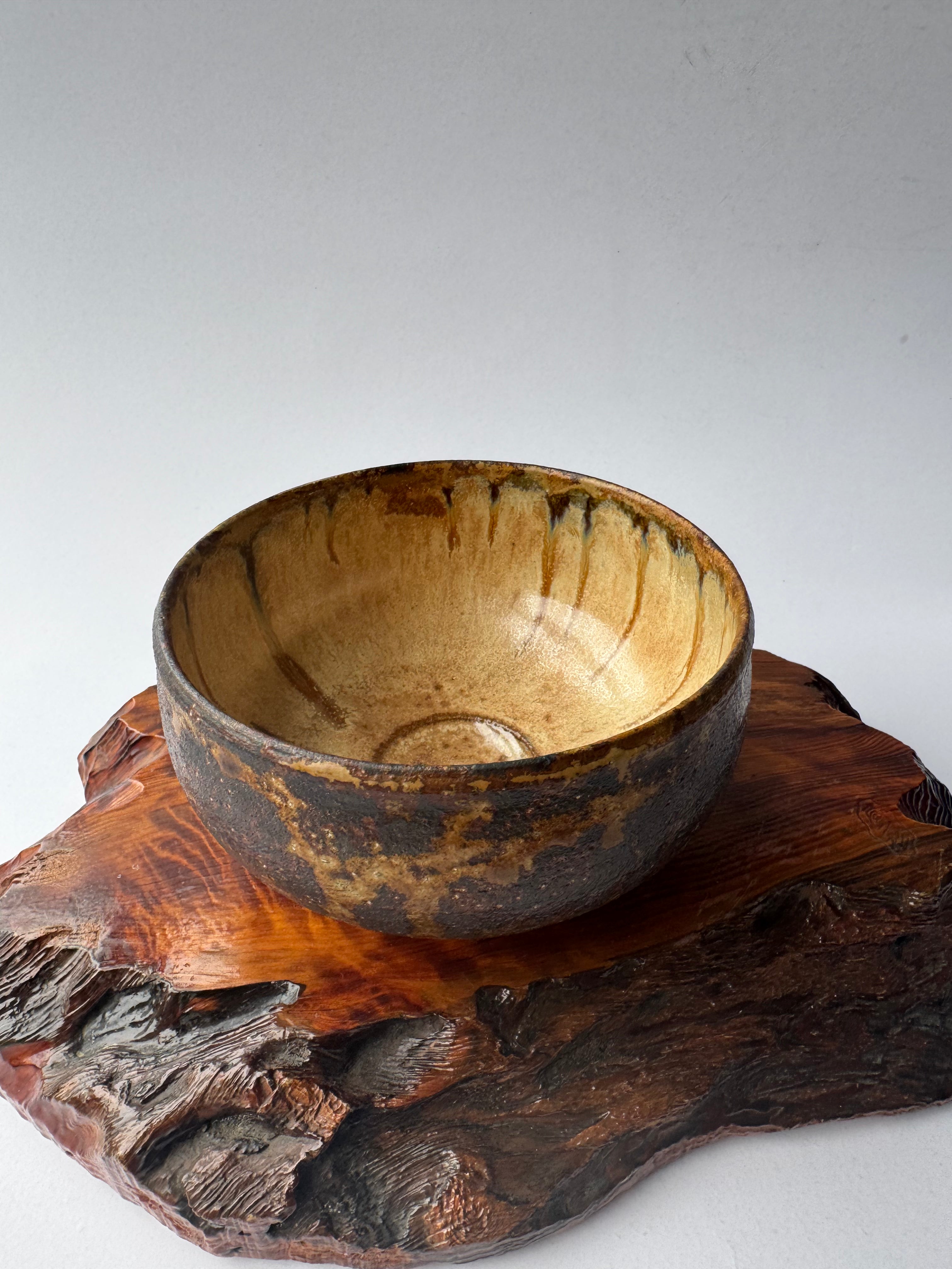 Wooden bowl on a wooden stand with a white background