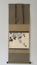 Decorative wall scroll with floral design on a plain background