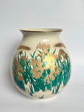 Decorative vase with floral design on a plain background
