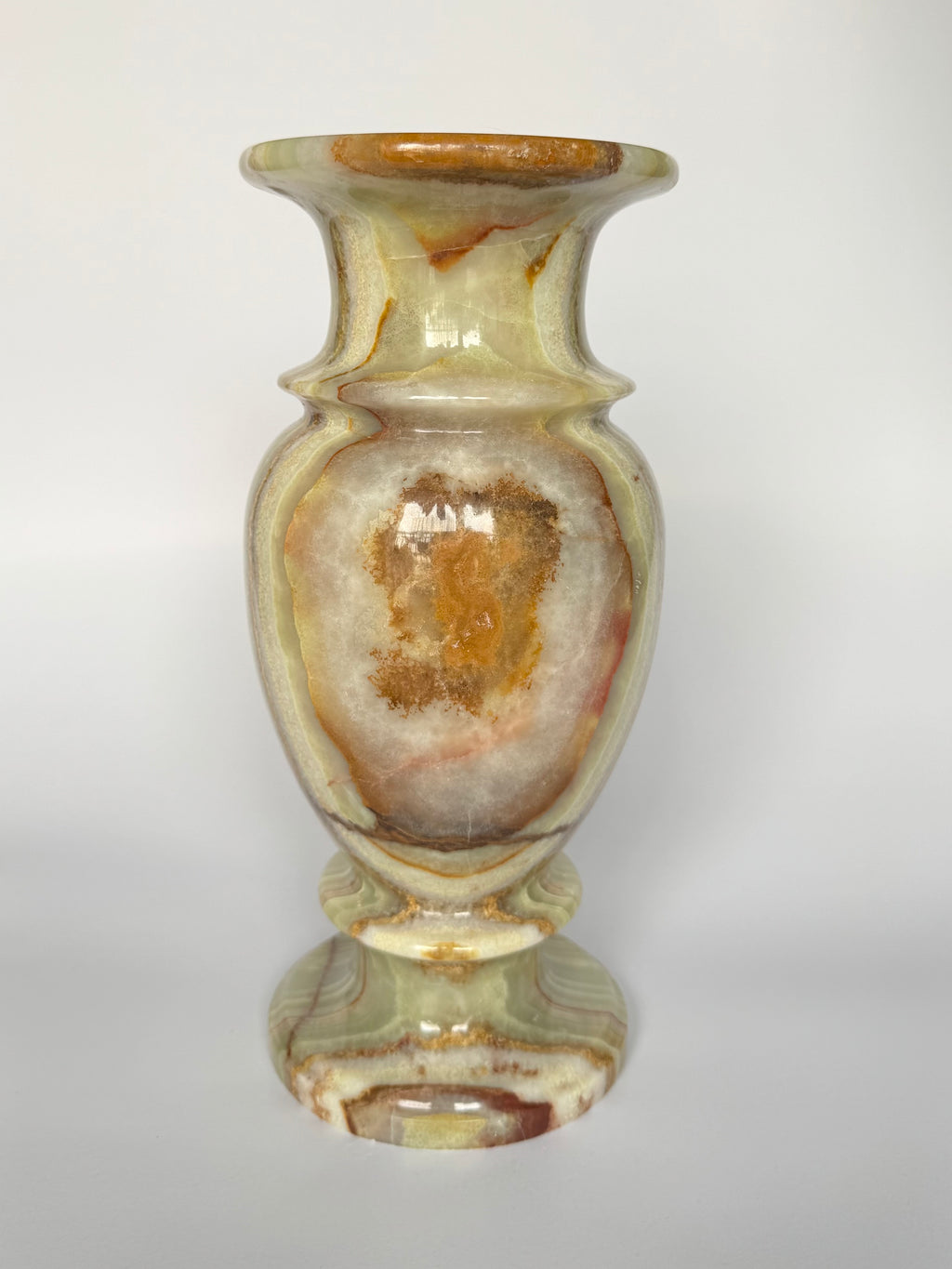 Decorative vase with marbled design on a white background