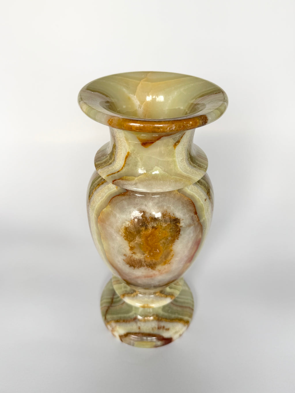 Decorative glass vase with brown and beige patterns on a white background