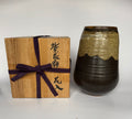 Wooden box with a purple ribbon and ceramic vase on a white background