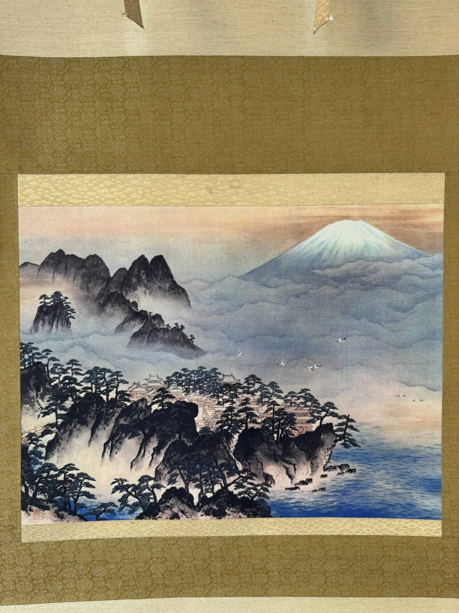 Traditional Japanese landscape painting of Mount Fuji and misty mountains.